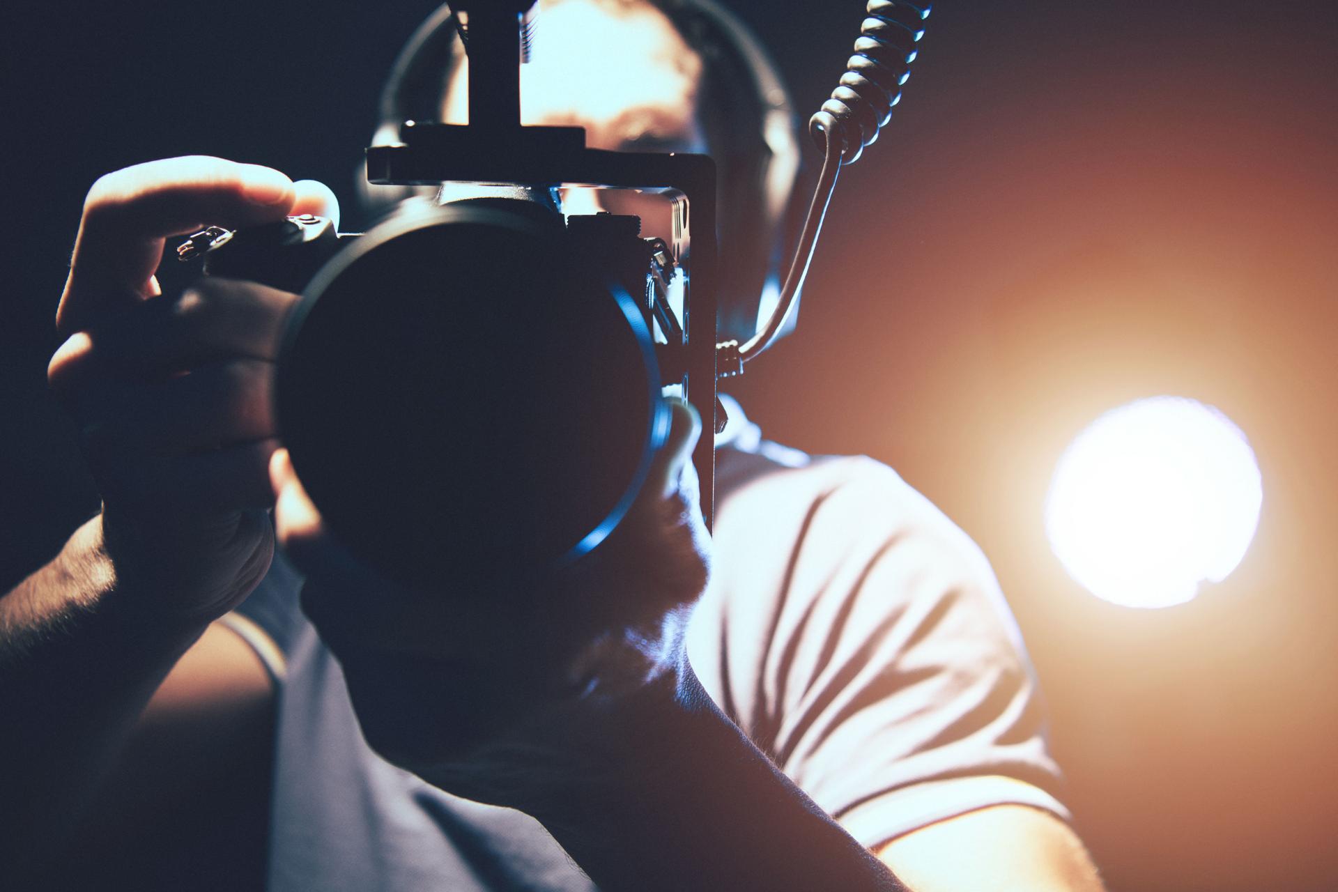 Videographer with Professional DSLR Camera in Hands